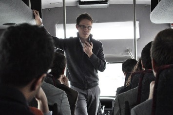 IESE MBA student Josh Lehr presents his business pitch en route to the next stop. 