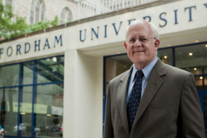 Headshot of Dean David Gautschi standing in front of Fordham University's business school.