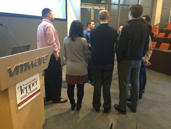 Tepper MBAs listen to an employee of VMware at VMware's Palo Alto campus on their Bay Area Tech Trek