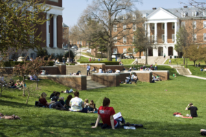 Students sitting and studying on the Mall with McKeldin Library and Jimenez Hall in the background.