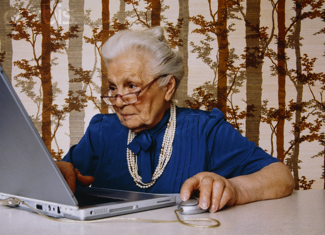 Senior Woman Using Laptop --- Image by © Jean Michel Foujols/zefa/Corbis
