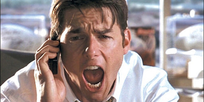 Image of Tom Cruise's character in the movie Jerry Maguire, shouting into a cell phone.