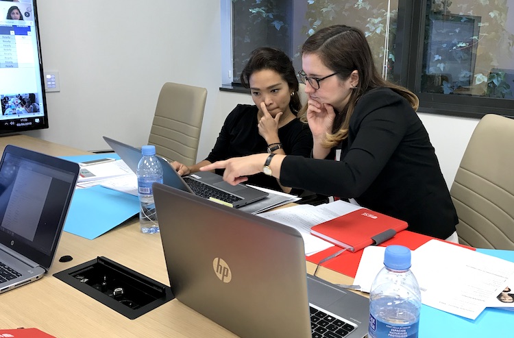 IESE Associate Admission Directors Karen Crisostomo and Natalia Antip confer over a candidate’s application file
