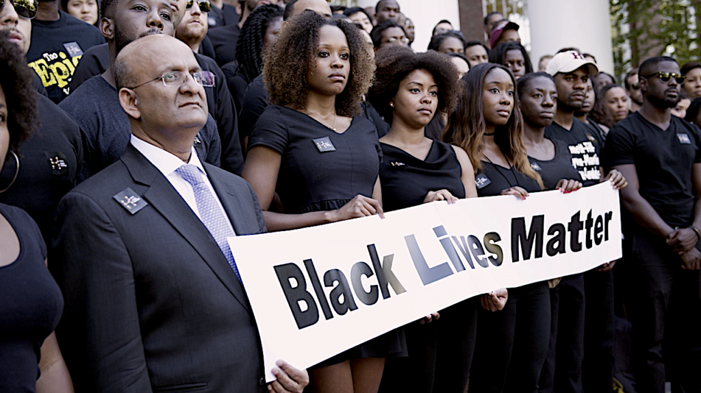 Harvard Business School Dean Nitin Nohria poses with students during a Black Lives Matter protest on campus