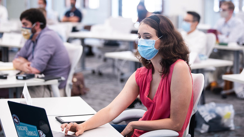 A student wears a surgical mask in a classroom at Rice University's Jones Graduate School of Business.