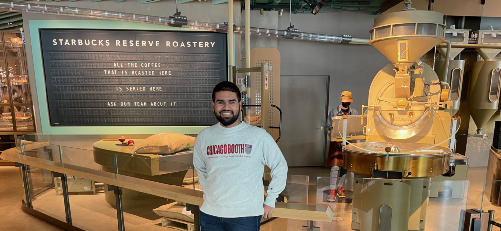 Talha Siddiqui, who will graduate with an MBA from Chicago Booth on June 4, poses for a photo at the Starbucks Reserve Store in Chicago. (Courtesy photo)