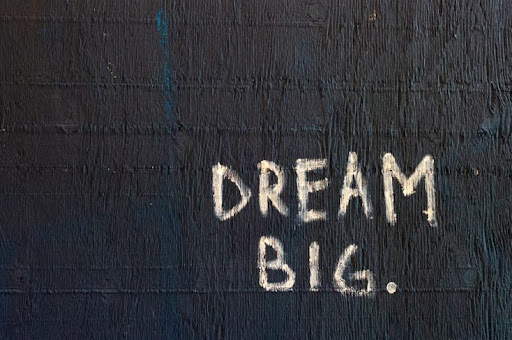 dream big written in chalk on black background
